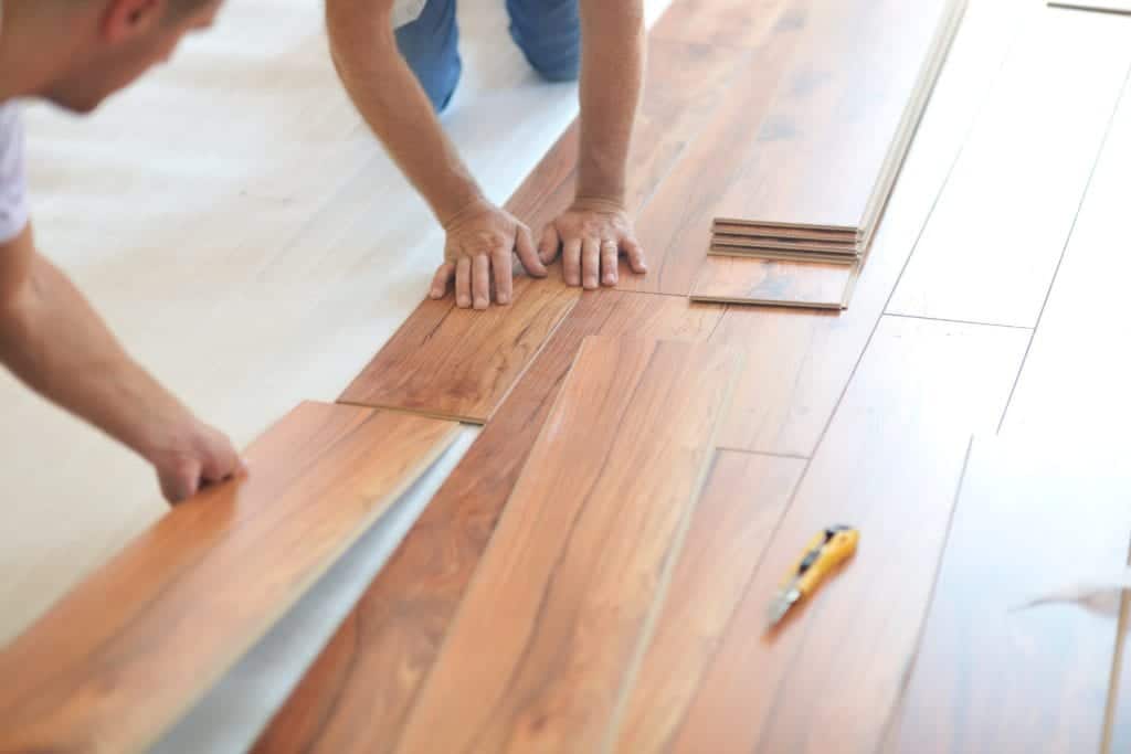 Crew installing wood planks for a hardwood flooring Frisco TX project