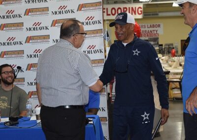 Drew Pearson Shaking Hands With Nadine Floor Employee In The Event