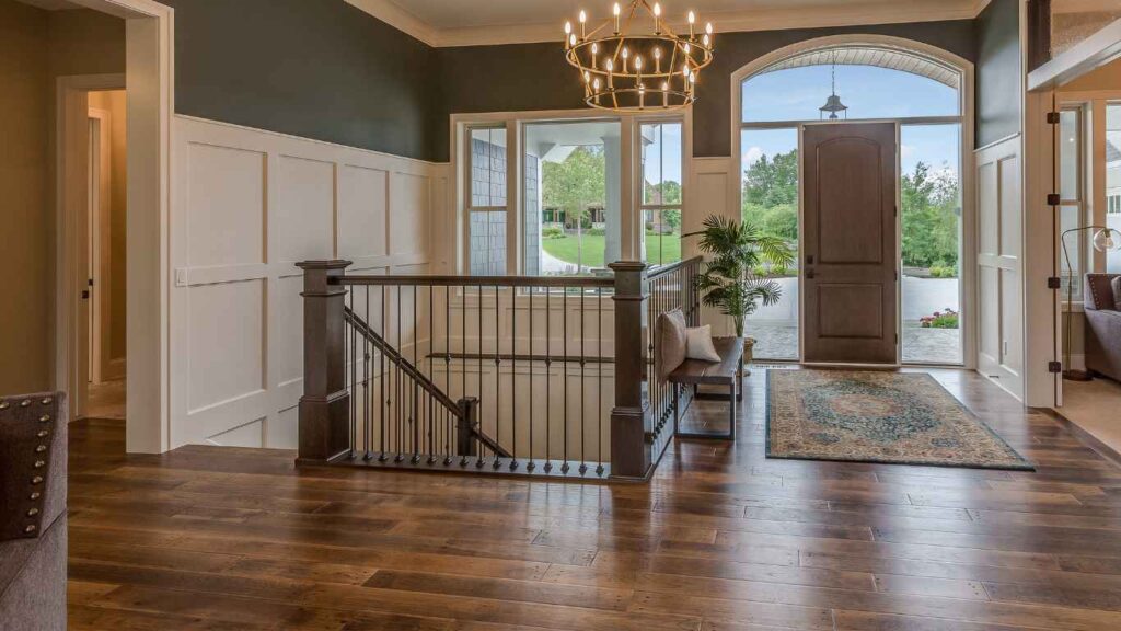 Hallway showing how to blend different flooring with dark wood and wainscoting