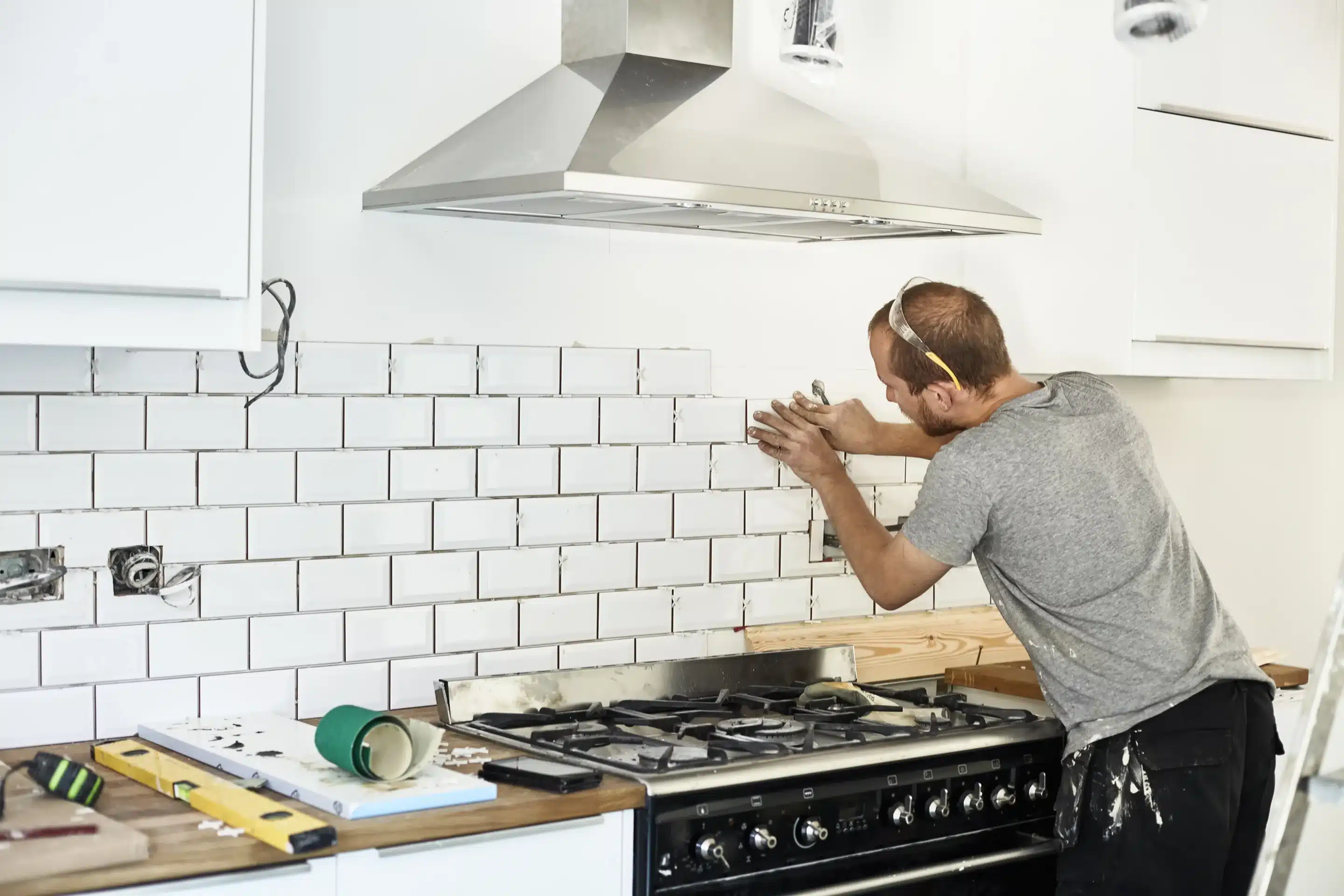 man doing Kitchen Backsplash Tile Installation Allen